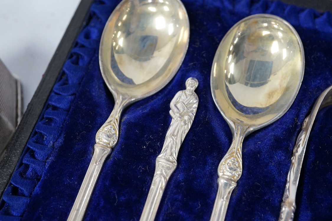 A George V silver mounted brass cased travelling timepiece, London, 1916, 70mm, together with a silver napkin ring, a pair of silver sugar tongs, a cased set of silver Victorian silver teaspoons with sugar tongs and a pl